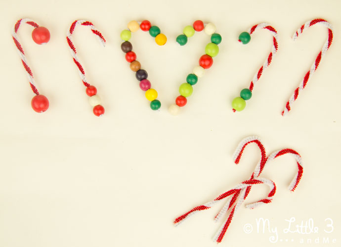 DIY CANDY CANE TREE ORNAMENTS - this pipecleaner and bead Christmas craft for kids is super simple and easy and lots of fun. Make lots of cute candy canes to decorate the Christmas tree. #christmas #christmascrafts #christmascraftsforkids #ornaments #candycane #kidscrafts #kidscrafts101 #kidscraftroom #christmasforkids #kidsactivities #finemotor